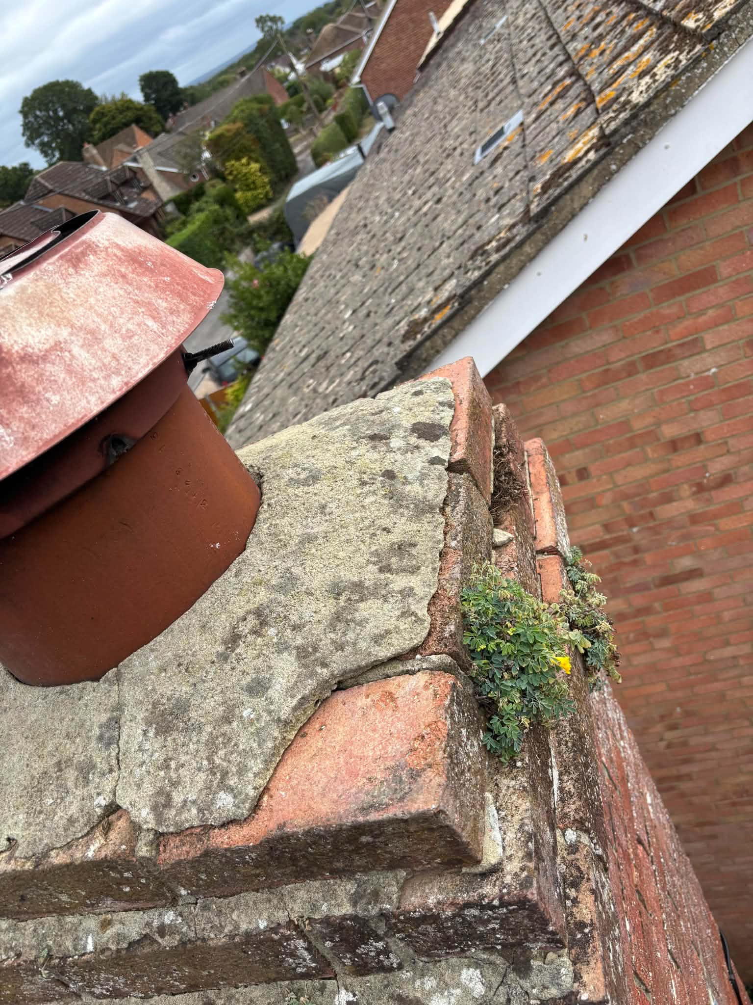 Chimney stack brickwork and pot seen from the roof in Hampshire