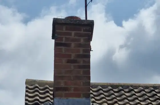 Chimney stack with lead flashing on a tiled roof in Hampshire