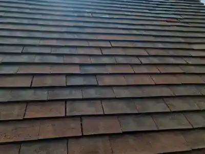 Clay tile roof after moss was removed by hand near Mortimer, Berkshire